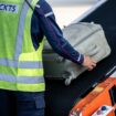 This picture taken on September 3, 2024 shows a staff member transferring baggages into a Cathay Pacific flight for departure in Kansai International Airport of Osaka Prefecture. - Kansai International Airport in Japan can't be held responsible for the less superlative performance of airlines or other stops in a traveller's journey, but it claims its handlers never lose a bag. (Photo by Philip FONG / AFP) / TO GO WITH:  JAPAN-AVIATION-AIRPORT