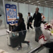 FILE- Passengers walk out of the International arrival hall of the Beijing Capital International Airport in Beijing, March 14, 2023. (AP Photo/Ng Han Guan, File)