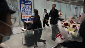 FILE- Passengers walk out of the International arrival hall of the Beijing Capital International Airport in Beijing, March 14, 2023. (AP Photo/Ng Han Guan, File)
