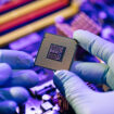 Laboratory technician holds a powerful processor in his hands. CPU computer processor shallow focus. CPU socket of the computer's motherboard. Concept of computer, motherboard, hardware and technology
