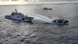 In this image made from a video provided by the National Task Force for the West Philippine Sea (NTF-WPS), a Chinese coast guard vessel, left, fires a powerful water cannon on a Philippine bureau of fisheries vessel near a disputed shoal in the South China Sea Wednesday Dec. 4, 2024. (National Task Force for the West Philippine Sea via AP)