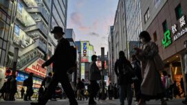 People walk outside a train station in the Akihabara district of Tokyo on May 9, 2024. (Photo by Richard A. Brooks / AFP)
