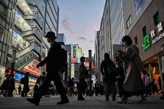 
					People walk outside a train station in the Akihabara district of Tokyo on May 9, 2024. (Photo by Richard A. Brooks / AFP)