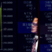 FILE PHOTO: A passerby is reflected on an electronic screen displaying a graph showing recent Japan's Nikkei share average movements and stock prices as the share average hits a record high in Tokyo, Japan February 26, 2024.  REUTERS/Issei Kato/File Photo