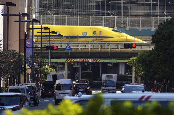 
					Shinkansen high-speed test trains or known as Doctor Yellow, travels along an overpass in the middle of downtown Monday, Feb. 6, 2023, in Tokyo. The special trains primarily monitor the high-speed rail network's condition. (AP Photo/Eugene Hoshiko)