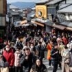 Tourists walk past shops and restaurants up the hill leading to Kiyomizu-dera Temple in Kyoto on Jan. 13. Photographer: Paul Miller/AFP/Getty Images