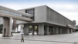 Hiroshima, Japan - April 21, 2012: People walk past famous Peace Memorial Museum on April 21, 2012 in Hiroshima, Japan. It educates people about the infamous atomic bombing.