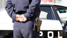 Kagawa, Japan - January 8, 2019: Back view of Japanese police officer with patrol car, in Kagawa, Japan.