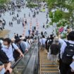 People ride one of the outdoor escalators as they visit the 2025 Osaka Expo in the city of Osaka on May 21, 2025. The number of foreign visitors to Japan soared 28.5 percent in April year-on-year to a record 3.91 million, official figures showed on May 21. (Photo by Richard A. Brooks / AFP)