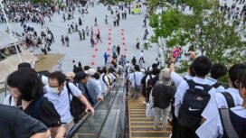 People ride one of the outdoor escalators as they visit the 2025 Osaka Expo in the city of Osaka on May 21, 2025. The number of foreign visitors to Japan soared 28.5 percent in April year-on-year to a record 3.91 million, official figures showed on May 21. (Photo by Richard A. Brooks / AFP)