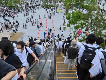 People ride one of the outdoor escalators as they visit the 2025 Osaka Expo in the city of Osaka on May 21, 2025. The number of foreign visitors to Japan soared 28.5 percent in April year-on-year to a record 3.91 million, official figures showed on May 21. (Photo by Richard A. Brooks / AFP)