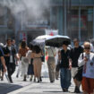 Pedestrians walk under a cooling mister (top L) while sheltering from the sun as the summer heat returns across the country, along a street in the Yuruakucho area of Tokyo on June 16, 2024. (Photo by Richard A. Brooks / AFP)