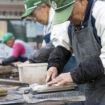 Retirees sharpen knives as part of the Silver Jinzai Service in Tokyo, Japan on Dec. 15 2015. The service, which aims to provide light work for the elderly, first came into into existence in 1975. Photographer: Rob Gilhooly