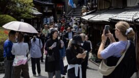 Tourists walk along a street in Kyoto, Japan, on Saturday, April 13, 2024. The yen dropped to a three-decade low against the dollar this week on prospects that despite the BOJs policy shift, yield differentials will remain wide between Japan and the US. Photographer: Buddhika Weerasinghe/Bloomberg