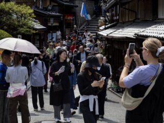 Tourists walk along a street in Kyoto, Japan, on Saturday, April 13, 2024. The yen dropped to a three-decade low against the dollar this week on prospects that despite the BOJs policy shift, yield differentials will remain wide between Japan and the US. Photographer: Buddhika Weerasinghe/Bloomberg