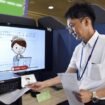 Masaharu Sugawara, a local government official of Ichinoseki, Iwate Prefecture, uses an artificial intelligence-powered terminal in a demonstration on Aug. 4, 2025, at the city's office. (Kyodo)