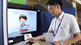 Masaharu Sugawara, a local government official of Ichinoseki, Iwate Prefecture, uses an artificial intelligence-powered terminal in a demonstration on Aug. 4, 2025, at the city's office. (Kyodo)