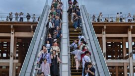 People ride one of the outdoor escalators as they visit the 2025 Osaka Expo in the city of Osaka on May 21, 2025. The number of foreign visitors to Japan soared 28.5 percent in April year-on-year to a record 3.91 million, official figures showed on May 21. (Photo by Richard A. Brooks / AFP)