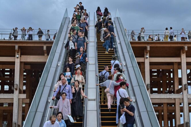 
					People ride one of the outdoor escalators as they visit the 2025 Osaka Expo in the city of Osaka on May 21, 2025. The number of foreign visitors to Japan soared 28.5 percent in April year-on-year to a record 3.91 million, official figures showed on May 21. (Photo by Richard A. Brooks / AFP)