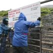 Workers put up a closure sign on a Mount Fuji trail in Fujinomiya, Shizuoka Prefecture, on Wednesday. Image: Kyodo