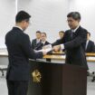 National Police Agency Commissioner-General Yoshinobu Kusunoki (right) hands a letter of appointment to Akira Uno, head of the agency's newly created information analysis office, at the agency in Tokyo on Wednesday. | JIJI