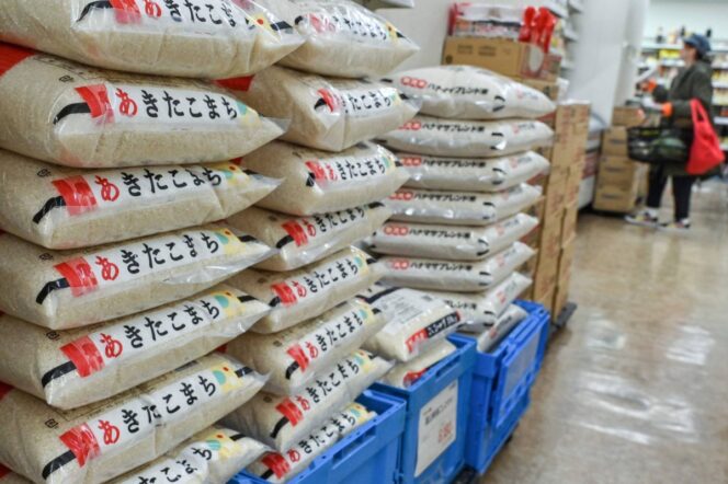
					(FILES) This file photo taken on November 22, 2024 shows bags of rice stacked in a supermarket in central Tokyo. The Japanese government said on February 14, 2025 it will release its stockpile of rice -- the nation's cherished staple food -- reserved for emergency use in response to soaring prices. (Photo by Richard A. Brooks / AFP)