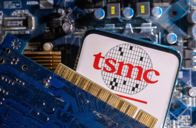 
					FILE PHOTO-A smartphone with a displayed TSMC (Taiwan Semiconductor Manufacturing Company) logo is placed on a computer motherboard in this illustration taken March 6, 2023. REUTERS/Dado Ruvic/Illustration/File photo