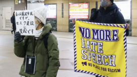 People carry messages against discrimination in Fujisawa, Kanagawa Prefecture, near Tokyo, on Jan. 29, 2026.