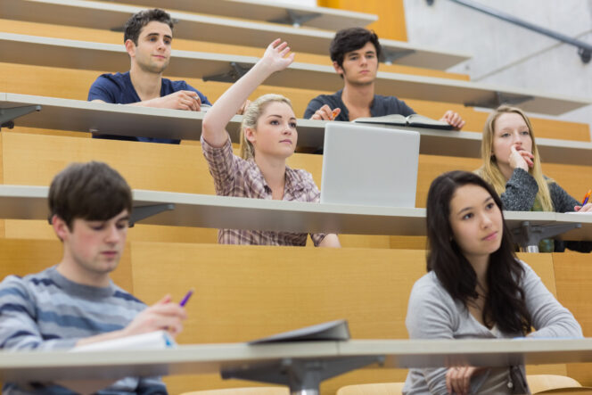 
					Students taking an active part in a lesson while sitting in a lecture hall