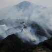 A helicopter conducts firefighting operations as wildfires continue in Otsuchi, Iwate Prefecture, Japan, April 26, 2026. REUTERS/Kim Kyung-Hoon