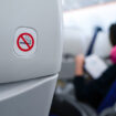 no smoking sign on plane seat.