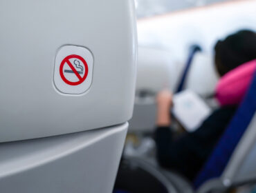 no smoking sign on plane seat.
