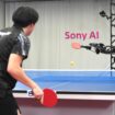 A table tennis robot built by Sony maneuvers to hit the ball back to its human opponent, Akito Saeki, during a match in Tokyo, Dec. 2025. (Sony AI via AP)