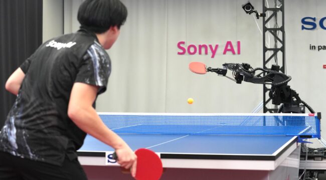 A table tennis robot built by Sony maneuvers to hit the ball back to its human opponent, Akito Saeki, during a match in Tokyo, Dec. 2025. (Sony AI via AP)