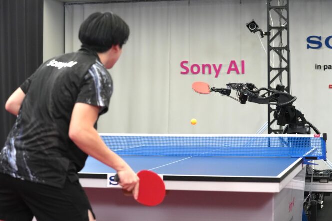 
					A table tennis robot built by Sony maneuvers to hit the ball back to its human opponent, Akito Saeki, during a match in Tokyo, Dec. 2025. (Sony AI via AP)