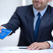 Japan consular officer giving passport to young woman, student visa approval
