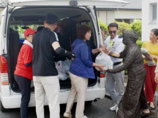 Staff members of the Vietnamese association in Kumamoto deliver relief supplies to foreign residents in the city of Yatsushiro, Kumamoto Prefecture, on Aug. 6. | JIJI @japantimes