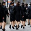 Female office workers wearing high heels, clothes and bags of the same colour make their way at a business district in Tokyo, Japan, June 4, 2019. REUTERS/Kim Kyung-Hoon