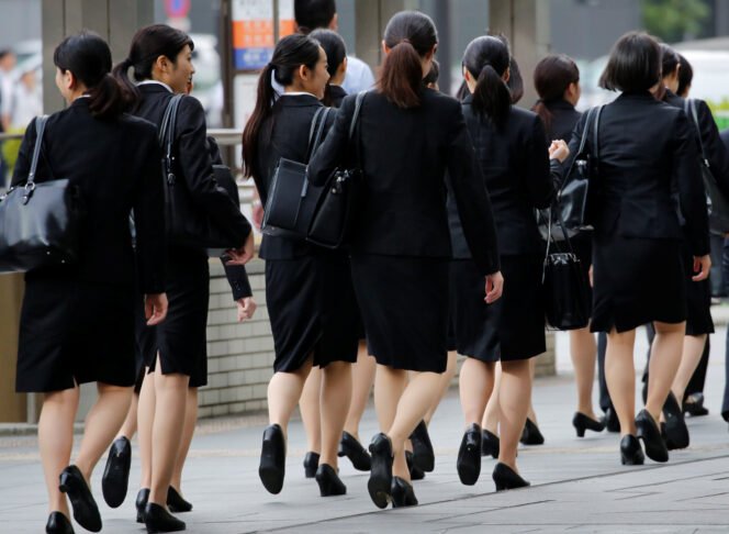
					Female office workers wearing high heels, clothes and bags of the same colour make their way at a business district in Tokyo, Japan, June 4, 2019. REUTERS/Kim Kyung-Hoon